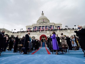 US Vice President-elect Kamala Harris (C-R) applauds as US President-elect Joe Biden (C-R) arrives for his inauguration as the 46th US President, on the West Front of the US Capitol in Washington, DC on January 20, 2021.