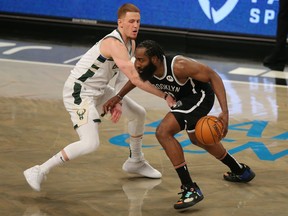 Brooklyn Nets shooting guard James Harden controls the ball against Milwaukee Bucks shooting guard Donte DiVincenzo during the fourth quarter at Barclays Center. The Nets defeated the Bucks 125-123.
