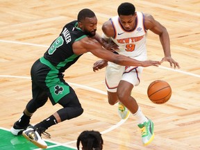Boston Celtics guard Kemba Walker defends against New York Knicks guard RJ Barrett in the third quarter at TD Garden.
