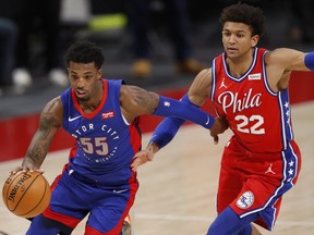 Detroit Pistons guard Delon Wright dribbles by Philadelphia 76ers guard Matisse Thybulle during the fourth quarter at Little Caesars Arena.