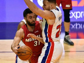 Heat guard Max Strus passes around Detroit Pistons forward Blake Griffin in the fourth quarter at American Airlines Arena.