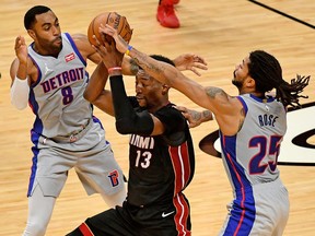 Miami Heat center Bam Adebayo controls the ball between Detroit Pistons guard Wayne Ellington and guard Derrick Rose during the second half at American Airlines Arena.