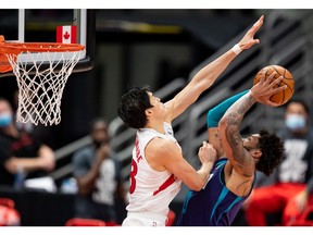 Toronto Raptors forward Yuta Watanabe attempts to block a shot by Charlotte Hornets forward Miles Bridges during the third quarter of a game at Amalie Arena.