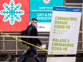 FILE PHOTO: A man walks through terminal 3, amid a spike in coronavirus disease (COVID-19) cases, at Pearson airport near Toronto, Ontario, Canada December 30, 2020.
