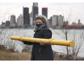 University of Windsor professor Maria Cioppa is shown along the Detroit riverfront holding a ground penetrating radar device that will help with the search for a mass grave of Norwegian immigrants who died of cholera in 1854.