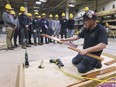 COVID-19 has complicated local high school co-op programs. In this Oct. 30, 2019, file photo, students are shown participating in the High School Construction Day event at the Carpenters Union Local 494 training facility in Tecumseh. The local's Brandon Fitch is shown teaching students how to install hardwood flooring.