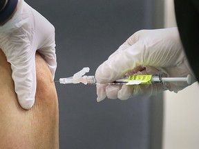 Shown here on Dec. 22, 2020, is an individual receiving one of the first local COVID-19 vaccines at the St. Clair College SportsPlex.