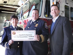 Then-Kingsville Fire Chief Chuck Parsons is shown in this Oct. 15, 2019, file photo accepting a donation from Enbridge Gas Inc. to pay for firefighter training materials. Shown here also is Nelly Green, with the Ontario Fire Marshal's Office, and Enbridge's Brian Chauvin.
