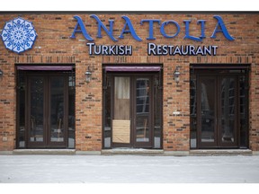 Boarded up windows are seen Sunday, Jan. 31, 2021, at the Anatolia Turkish Restaurant after a fire the previous day.