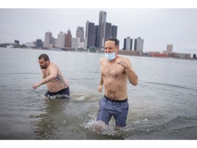 Dave Tesolin, right, and his cousin, Kyle Gignac, brave the polar conditions of the Detroit River, Saturday, Jan. 30, 2021, as part of a fundraising effort for the Alzheimer Society of Canada.