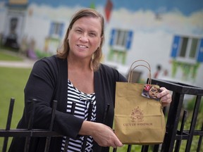 Kate Gibb, executive director of Drouillard Place, is pictured with a gift card distributed by the City of Windsor, Tuesday, July 21, 2020.