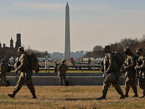 National Guard troops move along the National Mall the day after the House of Representatives voted to impeach President Donald Trump for the second time January 14, 2021 in Washington, DC.