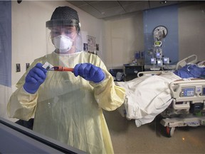 In this Jan. 18, 2021, photo, nursing student Bailey Zilliges is shown caring for a patient in the Windsor Regional Hospital Met campus intensive care unit.