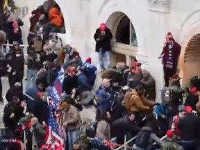 Donald Trump supporters drag a Capitol Hill police officer during the riot on Wednesday, Jan. 6, 2021.