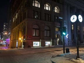 A clock shown shortly after 8 p.m. on the corner of an empty street in Montreal, Saturday, Jan. 9, 2021. The Quebec government imposed a curfew to help stop the spread of COVID-19 starting at 8 p.m. until 5 a.m. and lasting until Feb. 8.