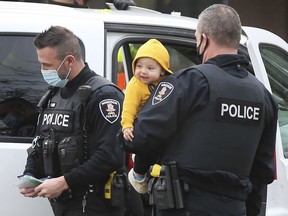 Crash scene cutie. Windsor Police Service Const. Colin Wemyss, right, holds a toddler at the scene of a minor accident on Wednesday, Jan. 6, 2021, on Riverside Drive East near George Avenue. The youngster was a passenger in a vehicle that was rear-ended. Paramedics checked out the child's mother who was driving the vehicle and both were determined to be fine before proceeding on their way.