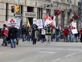 Anti-lockdown and anti-mask marchers on Ouellette Avenue in downtown Windsor on Jan. 10, 2021.