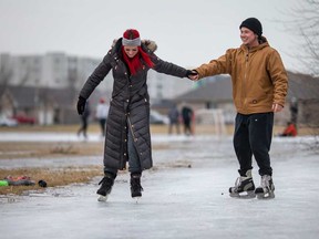 Amber Zahara and Jonathon Taylor do some skating on an icy patch near Banwell Road in Windsor's east end on Jan. 11, 2021.