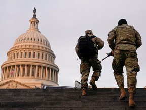 National Guard members walk at the Capitol, in Washington, U.S., January 15, 2021.