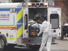 A paramedic transports a resident from The Village at St. Clair long-term care residence in Windsor on Tuesday, Jan. 5, 2021.