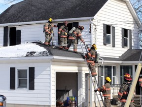 Kingsville firefighters work on the upper floors of a home on County Road 20 Thursday.  Kingsville Fire sent five vehicles to the scene and OPP closed both lanes of County Road 20 for about two hours.  All residents were out of the home and there were no injuries.