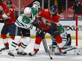 John Klingberg of the Dallas Stars defends against Jonathan Huberdeau of the Florida Panthers in front of Goaltender Anton Khudobin at the BB&T Center on February 22, 2021 in Sunrise, Florida.