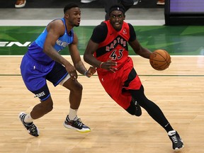 Pascal Siakam of the Toronto Raptors drives around Thanasis Antetokounmpo of the Milwaukee Bucks during the second half of a game at Fiserv Forum on February 18, 2021 in Milwaukee, Wisconsin.
