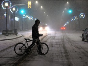 Winter wallop. Andrew Young, 44, crosses Sandwich Street near Mill Street as the snow was beginning to intensify around 7:30 p.m. on Thursday, Feb. 4, 2021.
