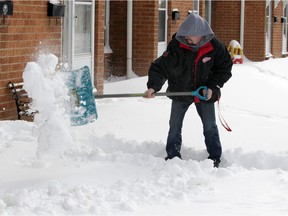 Snow shovelling is acceptable for high schoolers seeking to whittle down their community service hours requirement. There's certainly plenty of the white stuff now in Windsor. Here, on Tuesday, Feb. 16, 2021, Chris Israel clears snow on Lauzon Road.