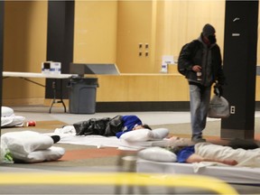 People are shown sleeping on the first floor of Windsor Public Library's former Central branch building on Ouellette Avenue on Wednesday, Feb. 17, 2021. It was converted on Monday into a temporary emergency shelter for the Downtown Mission due to COVID-19 outbreaks at its regular facilities.