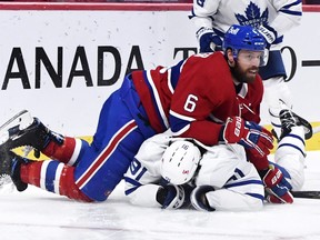 Habs' Shea Weber helps John Tavares do a face-plant on the Bell Centre ice on Wednesday night. The Leafs captain spent a few minutes in the 'quiet room' before returning to the game.