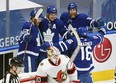 Maple Leafs' Auston Matthews (34) is greeted by teammates after scoring on Ottawa Senators goalie Matt Murray in the first period at Scotiabank Arena on Thursday, Feb. 18, 2021.