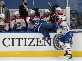 Montreal Canadiens defenceman Shea Weber (right) checks Toronto Maple Leafs centre Alexander Kerfoot.