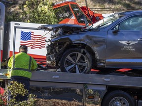 A sign for the Genesis Invitational golf tournament is seen on the door of the car that golf legend Tiger Woods was driving when seriously injured in a rollover accident on Feb. 23, 2021 in Rolling Hills Estates, Calif.