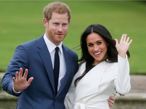 In this photo taken on Nov. 27, 2017, Britain's Prince Harry and his then-fiancée US actress Meghan Markle pose for a photograph in the Sunken Garden at Kensington Palace in west London following the announcement of their engagement.