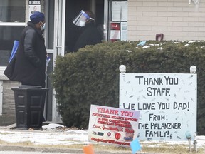 A deadly COVID-19 outbreak at Banwell Gardens Care Centre is over. Shown Feb. 4, 2021, are staff at the main entrance to the long-term care facility in Windsor.