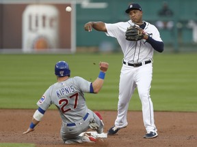 Detroit Tigers second baseman Jonathan Schoop turns a double play against Chicago Cubs second baseman Jason Kipnis on a ball hit by third baseman David Bote during the second inning at Comerica Park.