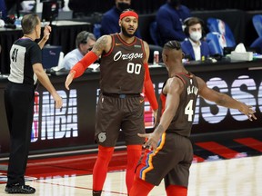 Portland Trail Blazers power forward Carmelo Anthony celebrates with forward Harry Giles III after a score against the Philadelphia 76ers during the second half at Moda Center.