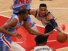 Brooklyn Nets forward Kevin Durant steals the ball from Washington Wizards guard Russell Westbrook in the second quarter at Capital One Arena.