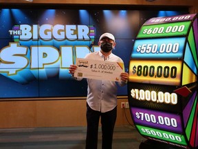 Saban Arayan, 49, of Windsor, holds his $1-million cheque after taking a turn on the Bigger Spin prize wheel at the OLG centre in Toronto.