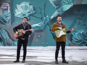 Austin Di Pietro (L) and Andrew Adoranti (R) - Windsor indie-rock duo The Bishop Boys - stand in front of a mural on Walker Road in Windsor on Feb. 17, 2021.
