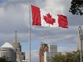 The Great Canadian flag in downtown Windsor is shown Oct. 8, 2020. with the Detroit skyline in the background.