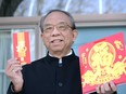 Stephen Tsui, president of the Essex County Chinese Canadian Association, holds a Lai See "lucky money" envelope and a lunar calendar on Feb. 11, 2021. The Year of the Ox officially begins Feb. 12, 2021.