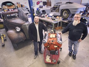 Giuseppe Prestia (L) and Jim Pollier (R) take a look at an engine in Pollier's garage on Feb. 15, 2021.