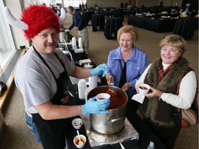 No crowds this year. Windsor firefighter Bill Hopkins, left,  serves up chili to Mary Ann Dafoe, and Karen Hodgson during the Windsor Firefighters Annual Chilifest held at the St. Clair Centre for the Arts on Nov. 13, 2015.