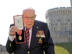 Captain Tom Moore poses after being awarded with the insignia of Knight Bachelor by Britain's Queen Elizabeth at Windsor Castle, in Windsor, Britain, July 17, 2020.