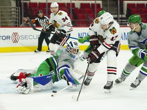 Carolina Hurricanes goaltender James Reimer stops the shot against Chicago Blackhawks center Mattias Janmark during the third period at PNC Arena.