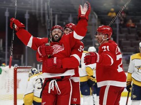 Detroit Red Wings center Sam Gagner celebrates with center Dylan Larkin and right wing Bobby Ryan after scoring a goal against Nashville Predators goaltender Pekka Rinne during the second period at Little Caesars Arena.