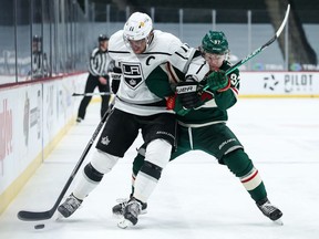 Los Angeles Kings center Anze Kopitar  and Minnesota Wild left wing Kirill Kaprizov battle for the puck in the first period at Xcel Energy Center.