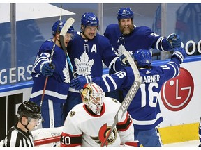 Toronto Maple Leafs forward Auston Matthews is greeted by team mates after scoring past Ottawa Senators goalie Matt Murray in the first period at Scotiabank Arena.